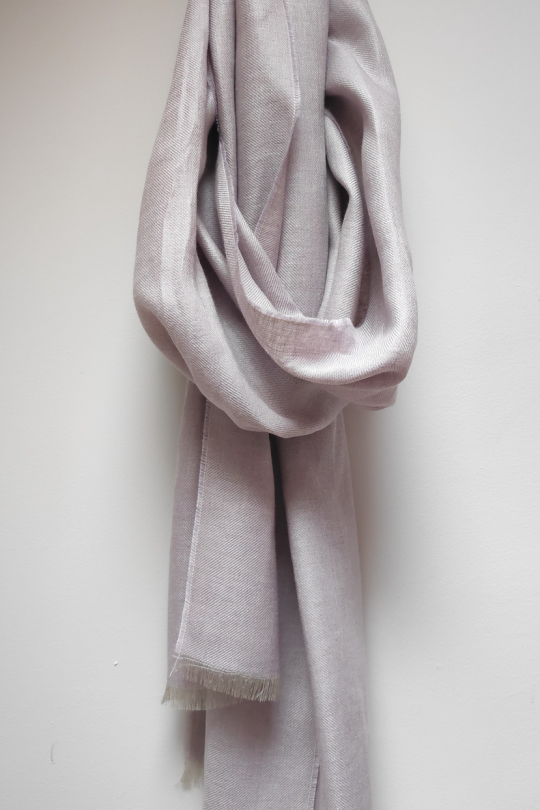 100% Irish Linen Scarf in a dusky lavender colour draped from a circle hook on a white wall.